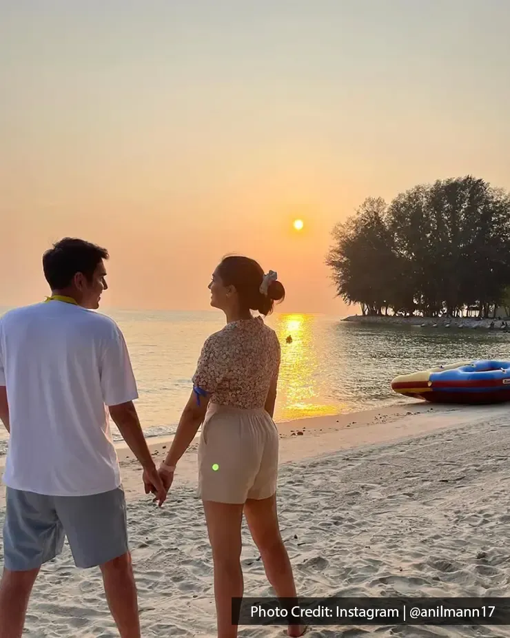 Couple holding hands at Pantai Cahaya Negeri beach during sunset - Lexis Hibiscus Port Dickson