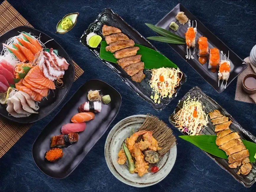 A table filled with an assortment of Japanese food - Lexis Suites Penang