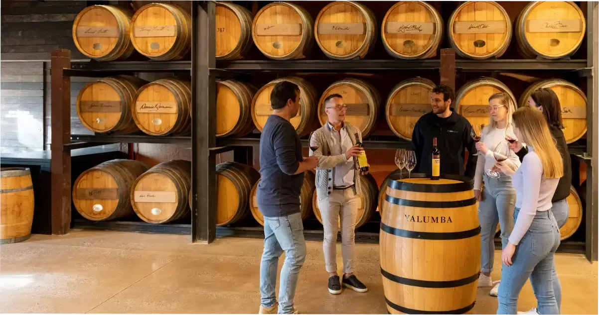 A group of people enjoying a wine tasting in The Barossa Valley.