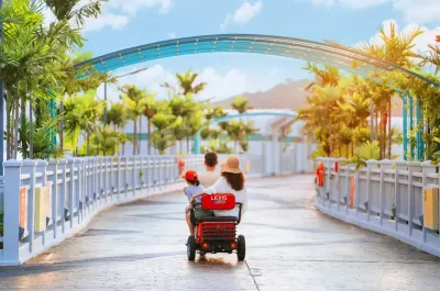 Family enjoying a ride on the resort electric scooter - Lexis Hibiscus Port Dickson