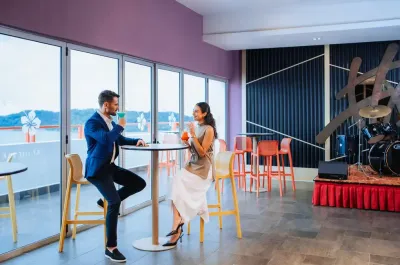 Couple toasting drinks in the resort bar - Lexis Hibiscus Port Dickson