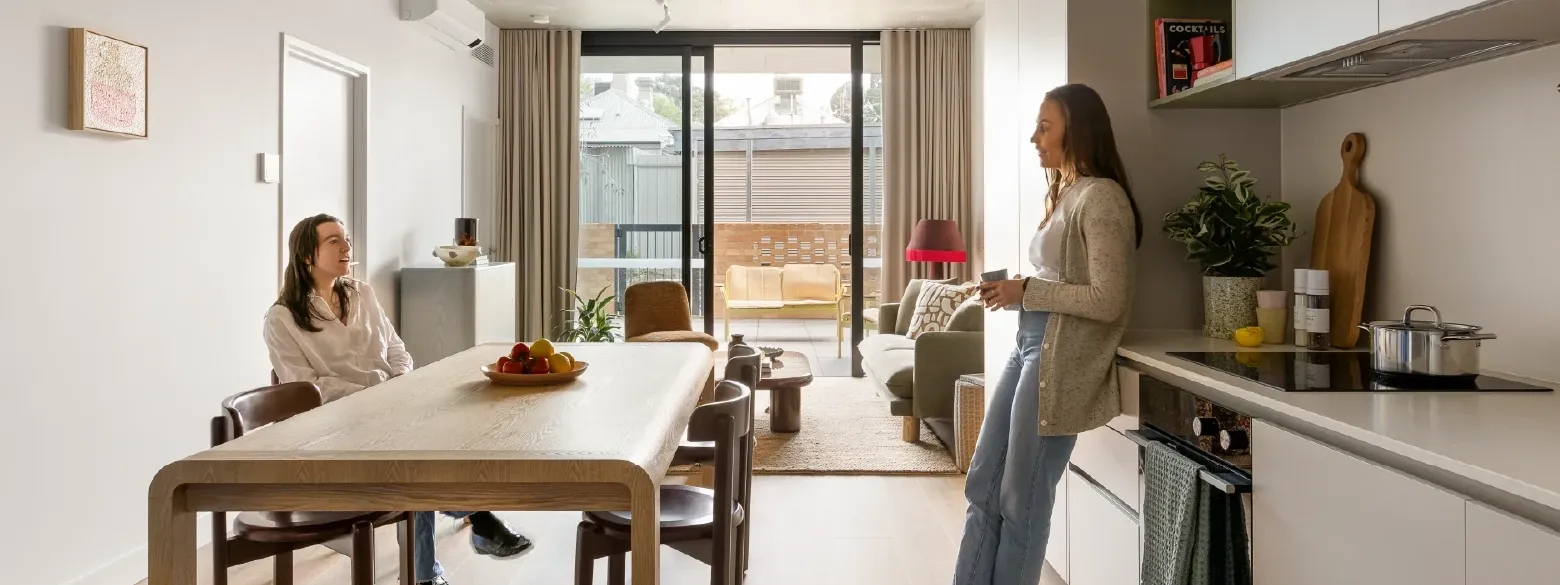Two women in the 2 Bedroom Apartment kitchen at Swift Walk in Kensington.