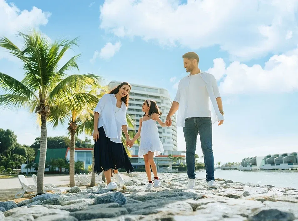 Parents and child enjoying a seaside walk at Lexis Hibiscus Port Dickson