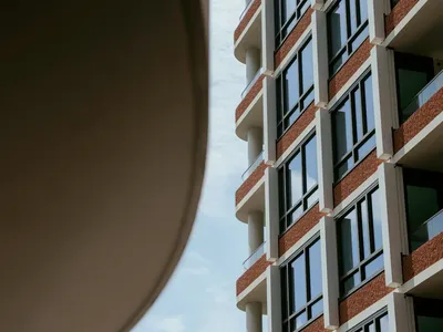 Modern building with glass windows and balconies.