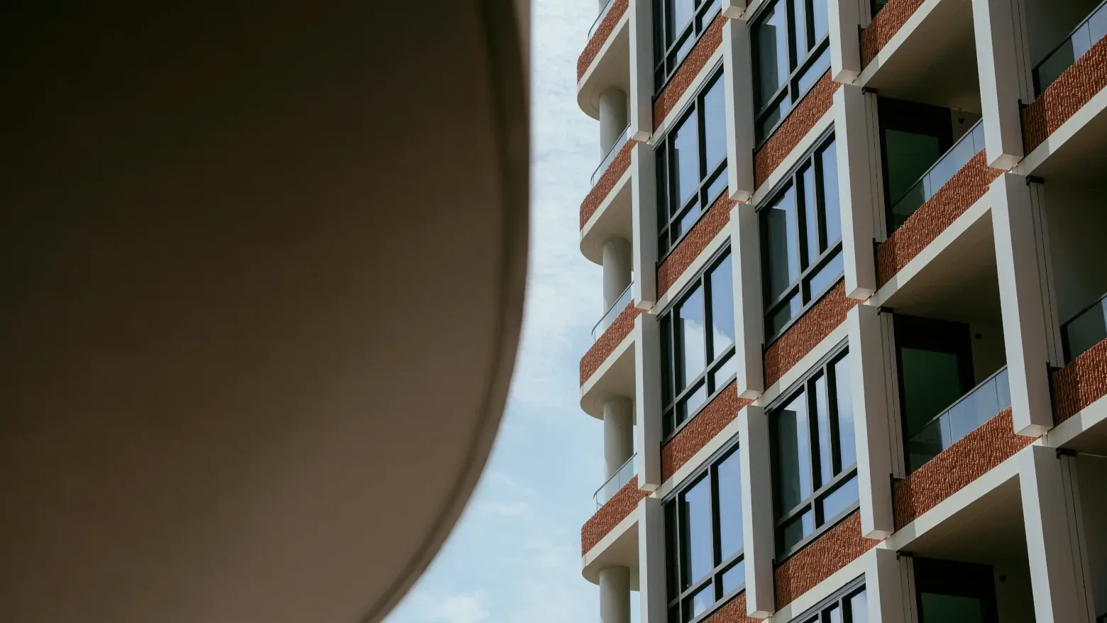 Modern building with glass windows and balconies.