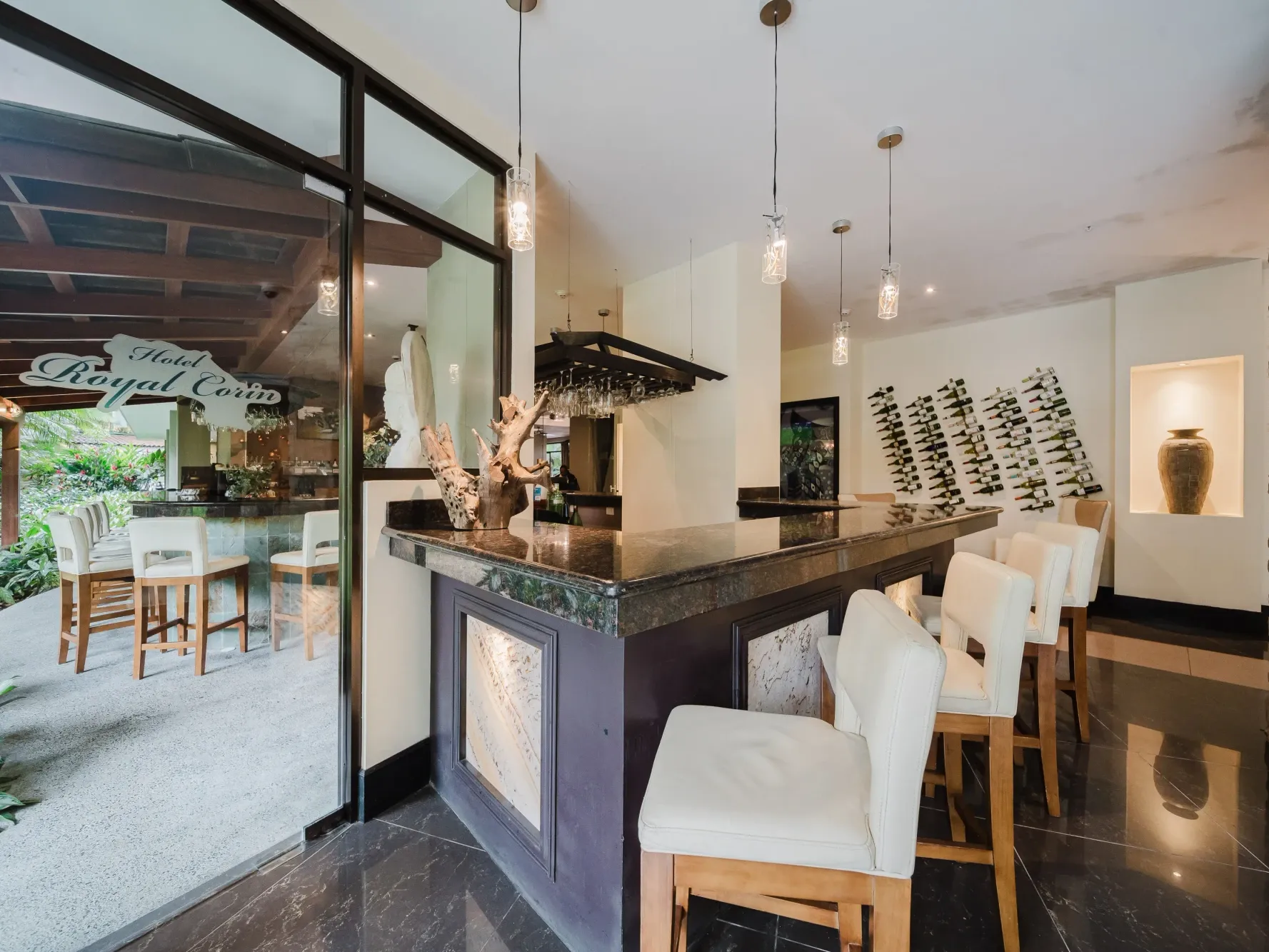 Upscale The Informal Lobby Bar with leather stools at Royal Corin, one of the best restaurants in La Fortuna, Costa Rica