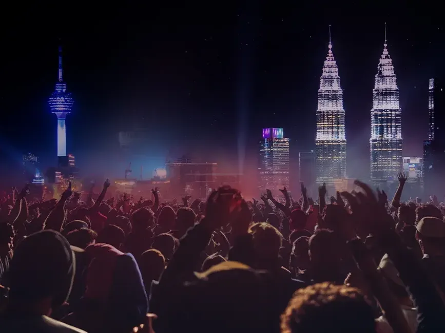 A diverse crowd enjoying a concert with a stunning city skyline visible behind them - Lexis Hotels & Resorts