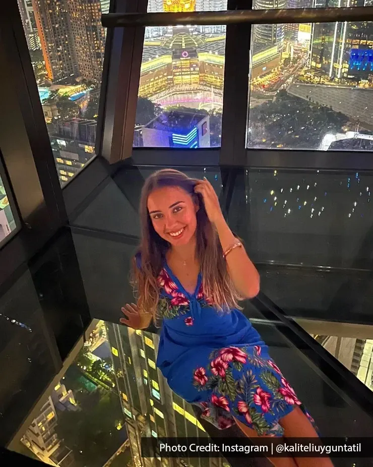 Woman poses on floor.