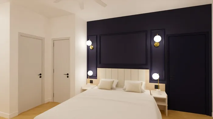 Chambre élégante avec lit double, murs bleu marine et lampes intégrées à Les Sources Callou.