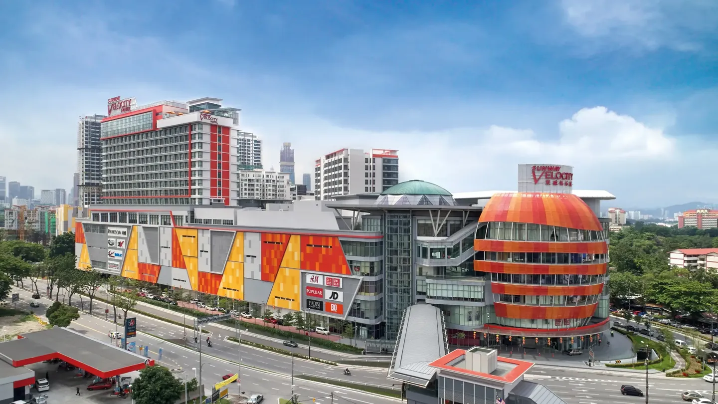 Sunway Velocity Hotel and Mall, with a colorful facade and the city skyline in the background