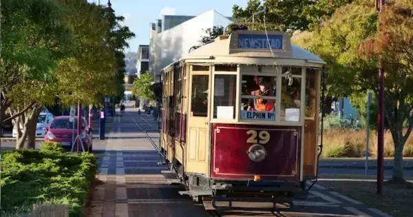 old cream and red tram on tracks with number 29 on the carriage