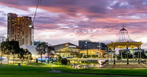 Adelaide Riverbank at dusk with a carousel and buildings in the background