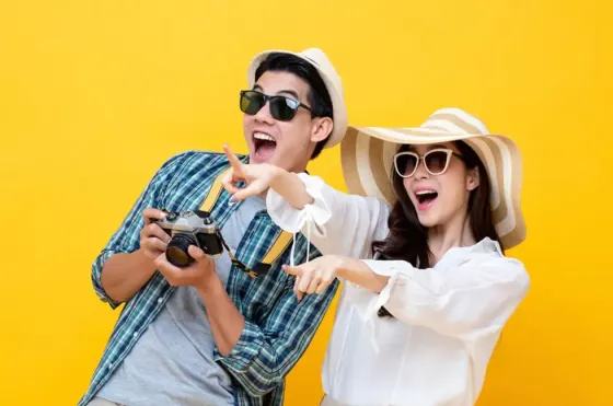 Couple wearing casual beach wear while holding a camera - Lexis Hotels & Resorts