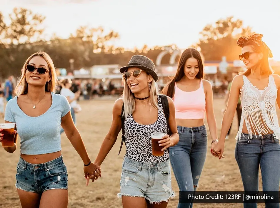 Friends walking together at an outdoor music festival