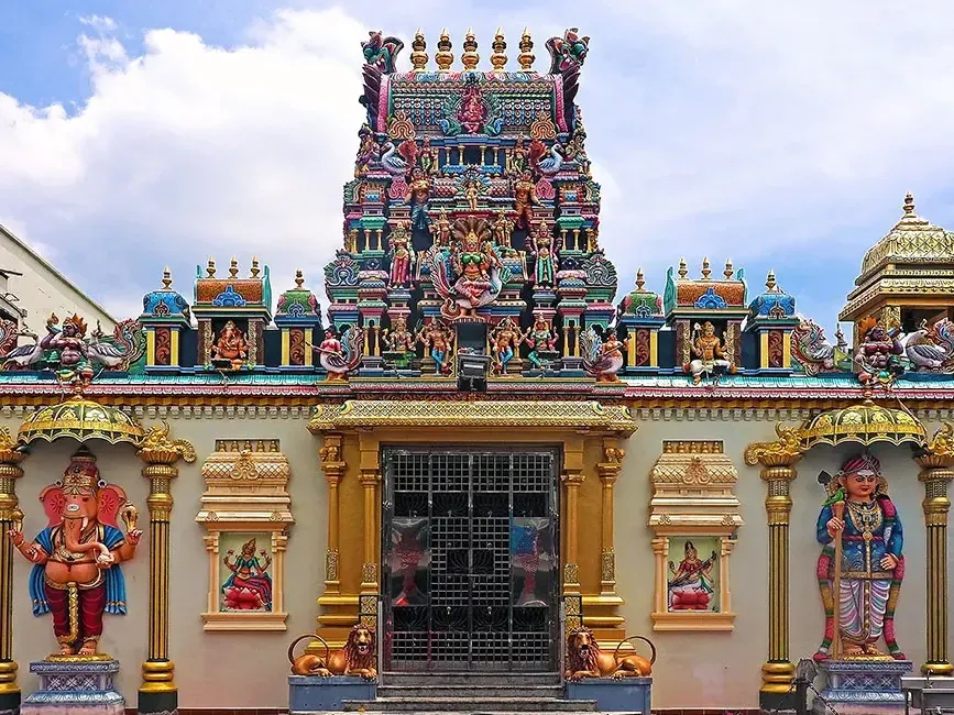 A view of the Sri Mahamariamman Temple, featuring intricate statues adorning its front façade - Lexis Suites Penang