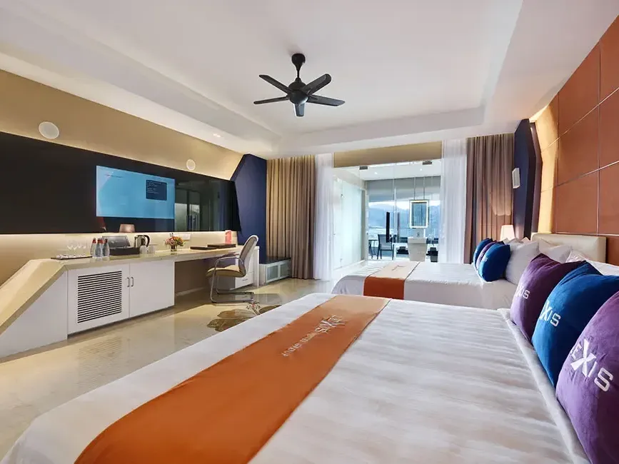 Modern and spacious executive pool suite room with twin beds and balcony view – Lexis Suites Penang