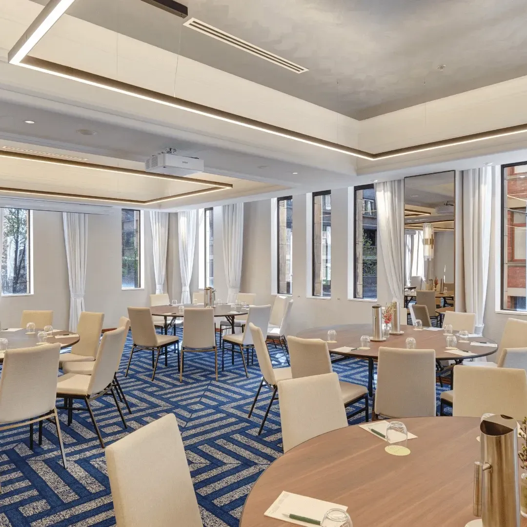Modern conference room at The Grace Hotel Sydney, featuring flexible seating, presentation screens and elegant heritage-inspired interiors