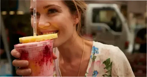 A woman sipping a fresh- made juice at one of Brisbane’s markets.