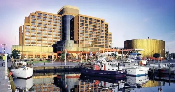 Hotel Grand Chancellor Hobart overlooking the waterfront at dusk, with boats moored in the harbour