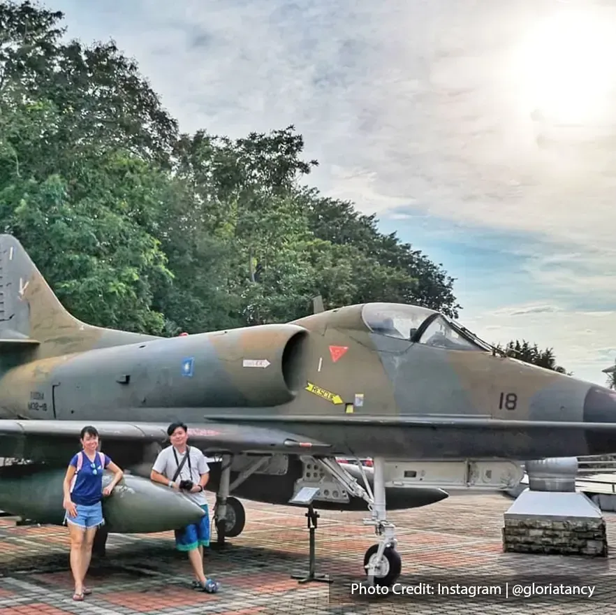 Tourist with fighter jets in army museum