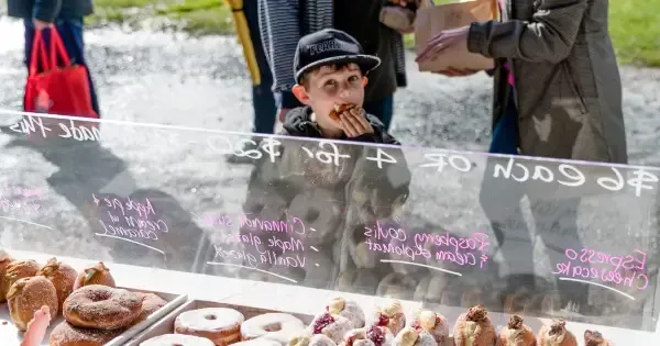 A child enjoys a baked treat at an Auckland market