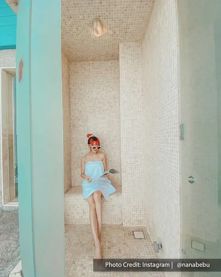 Woman in bathrobes posing in showerplace of Lexis Hibiscus