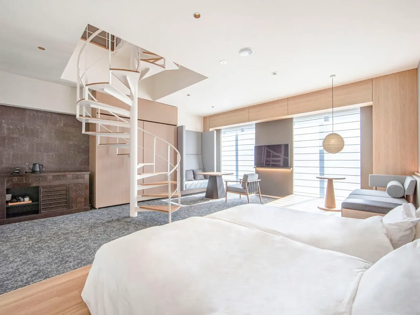 Comfy beds, spiral staircase and lounge area in Park Suite at Park Hotel Kyoto