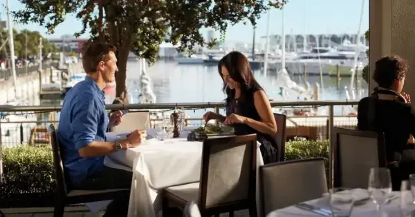 A couple dine by the harbour at Soul Bar & Bistro in Auckland