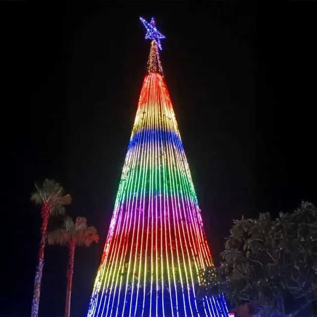 A large Christmas tree adorned with vibrant rainbow-colored lights - Lexis Hotel Group