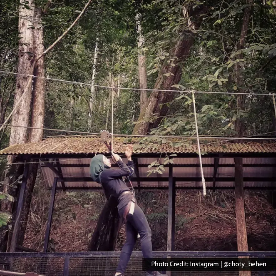 Outdoor adventure activity on a treetop zipline ride at Escape Theme Park Penang