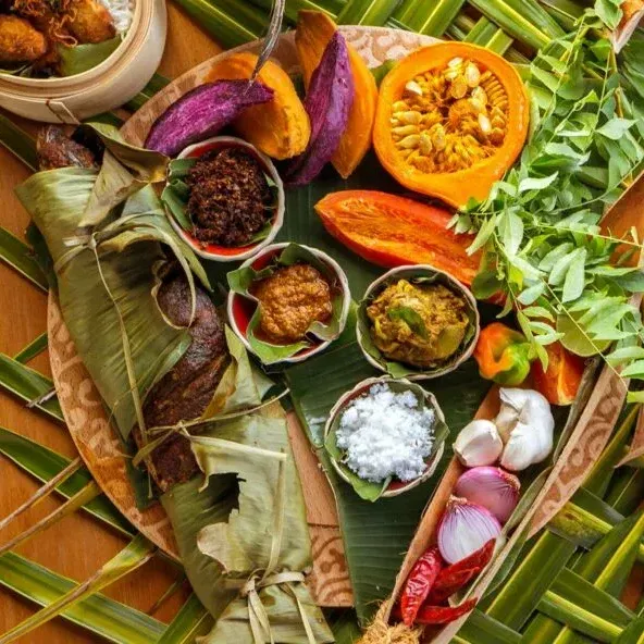 Traditional foods and spices arranged on banana leaves at Grand Park Kodhipparu, Maldives