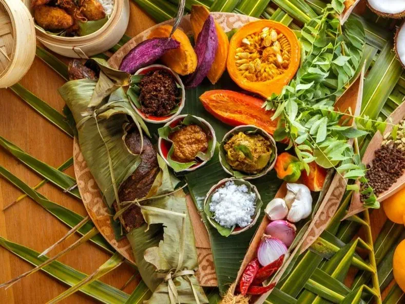 Traditional foods and spices arranged on banana leaves at Grand Park Kodhipparu, Maldives