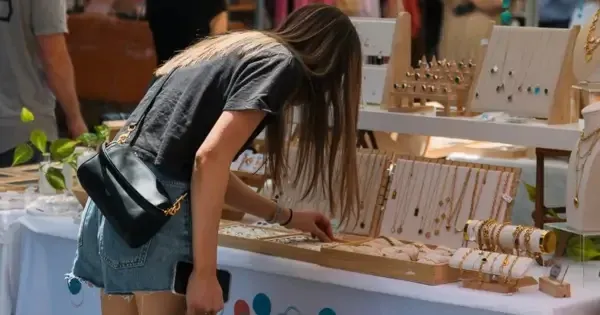 woman looking at jewellery at a market stall