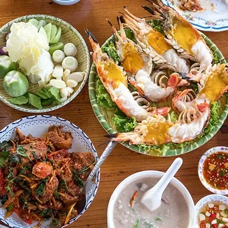 Seafood dishes with grilled prawns and dipping sauces.