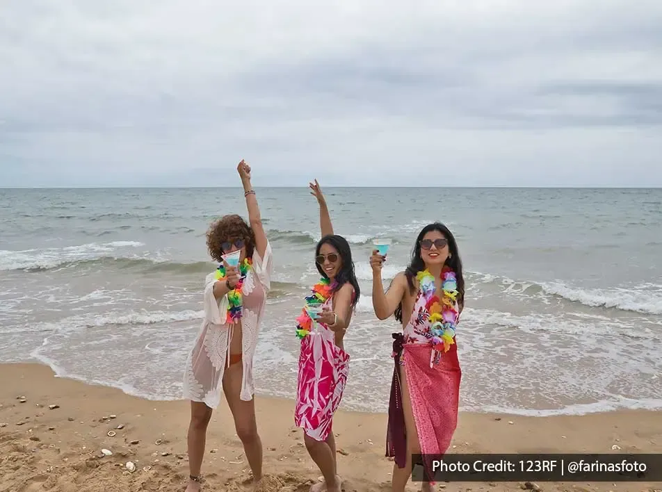 young ladies having fun and dancing on the beach - Grand Lexis PD