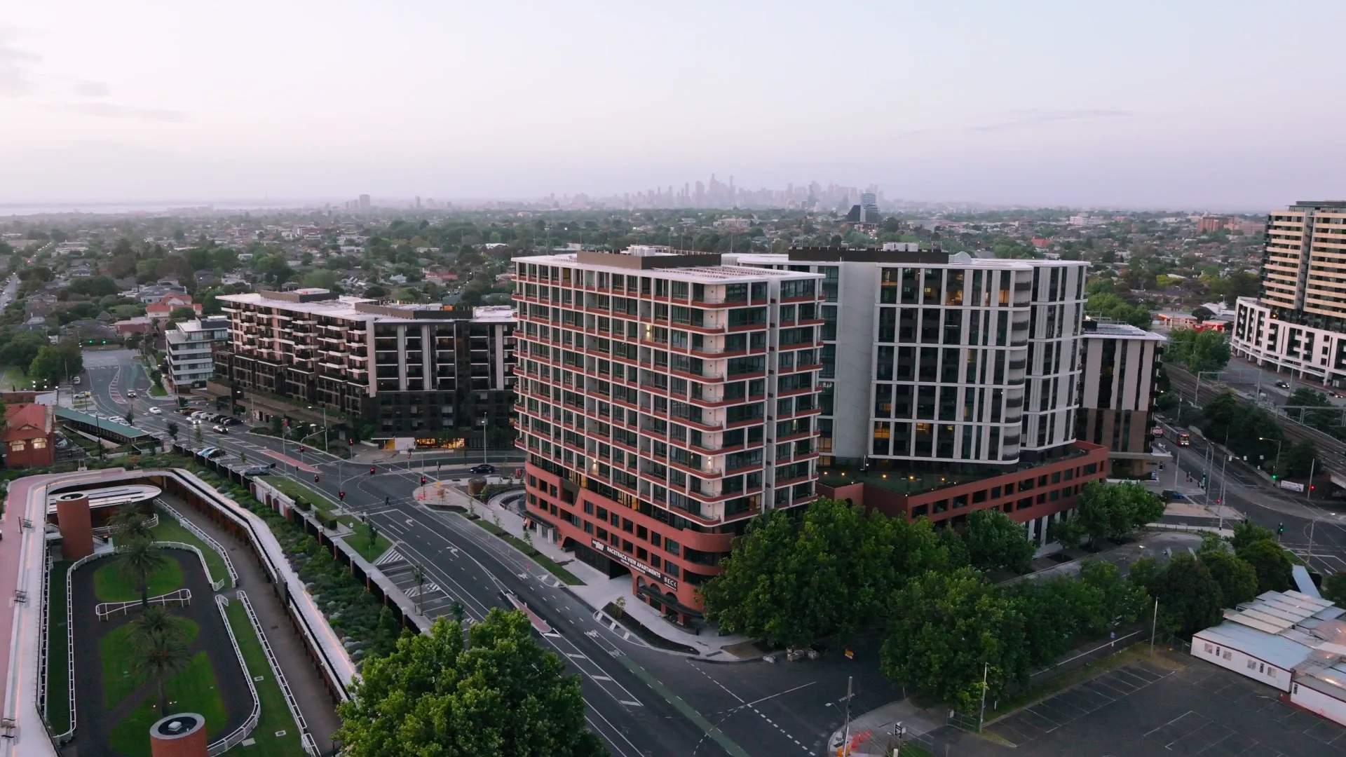 Aerial view of Caulfield Place with modern architecture and surrounding urban landscape.
