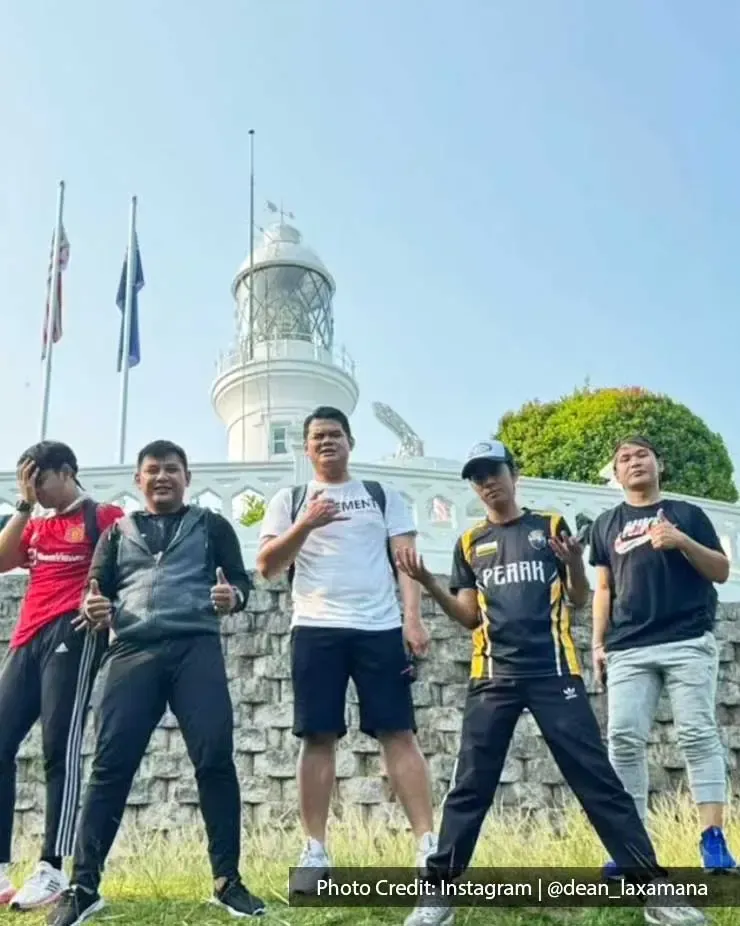 A group of people was taking a picture with Cape Rachado Lighthouse - Grand Lexis Port Dickson