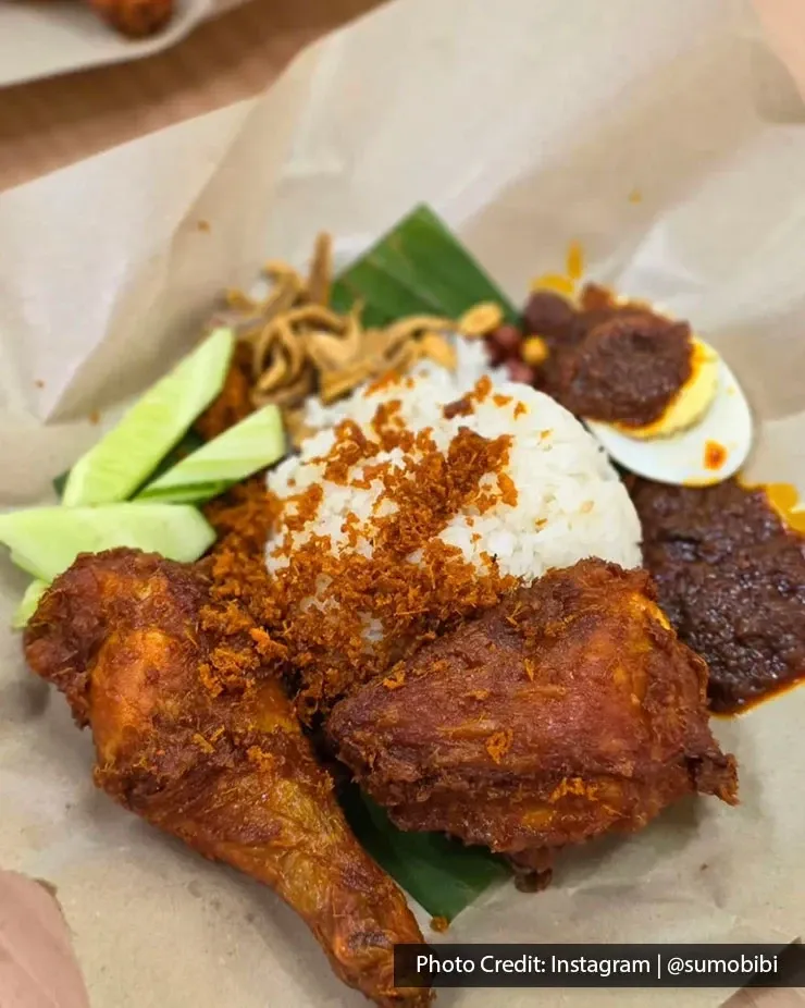 Nasi lemak with fried chicken, sambal, egg and cucumber.