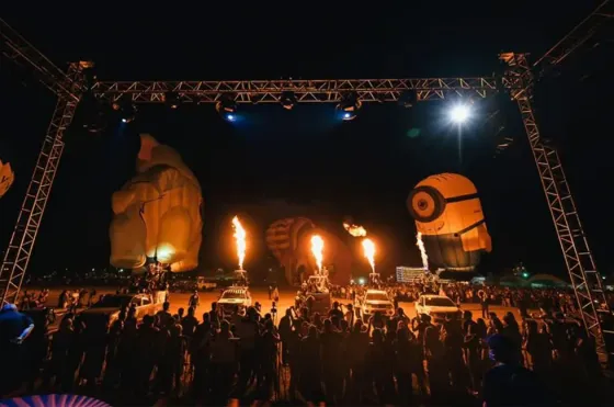 Penang hot air balloon fiesta at night with fire effects and spectators