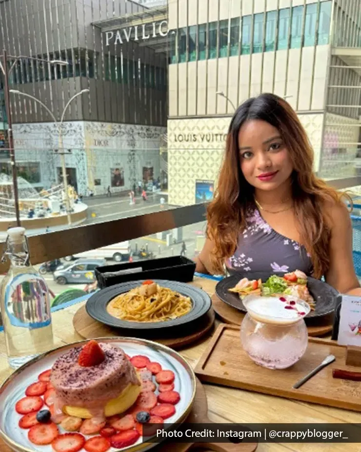 Diner posing with a background view of Pavilion Kuala Lumpur