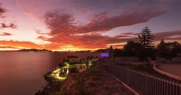 Vibrant pink sunset over the coast from The Strand waterfront Townsville