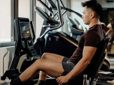 Man exercising on a recumbent bike in a gym at Caulfield Place.