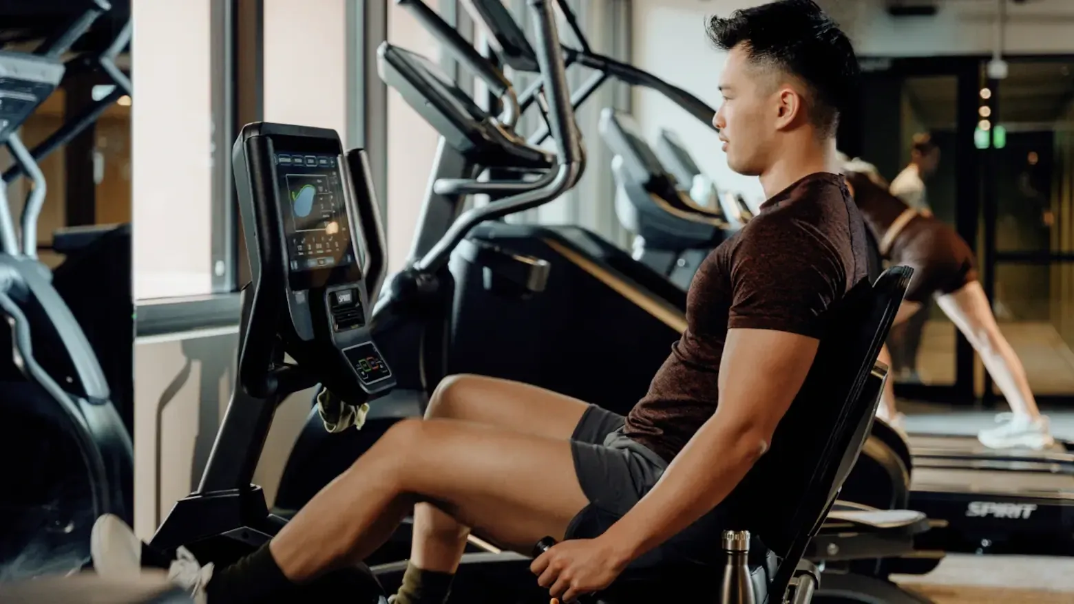 Man exercising on a recumbent bike in a gym at Caulfield Place.