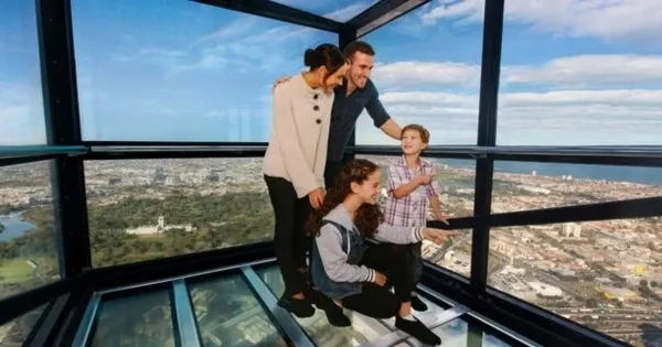 A family points to the views from inside Melbourne Skydeck