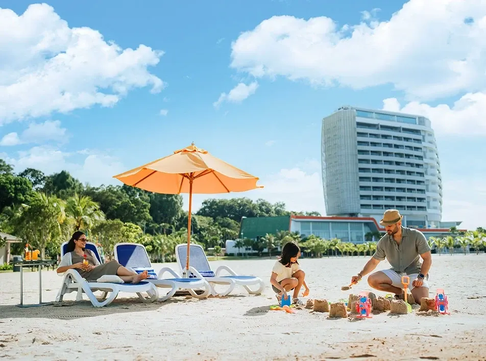Family enjoying beach activities during a Port Dickson resort stay