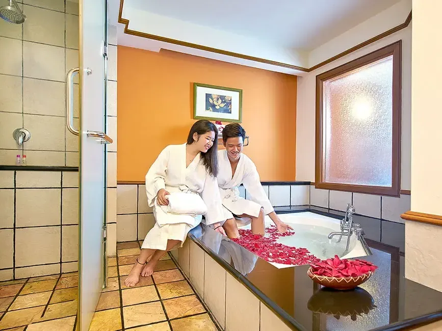 Couple enjoying a romantic rose petal bath in premium tower bathroom – Lexis Port Dickson