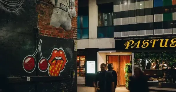 People walk the iconic AC/DC lane passing Pastuso and Cherry Bar