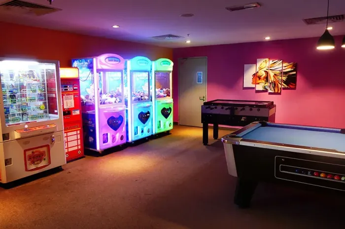 Interior of the games room featuring a pool table and arcade machines - Lexis Suites Penang
