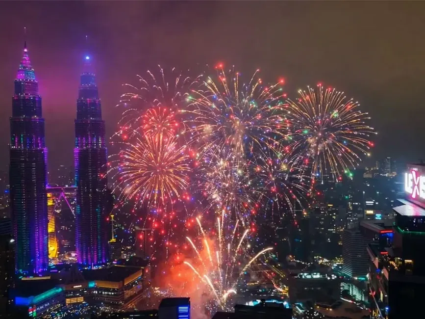 View of the city with colourful fireworks illuminating the night sky - Lexis Hotel Group