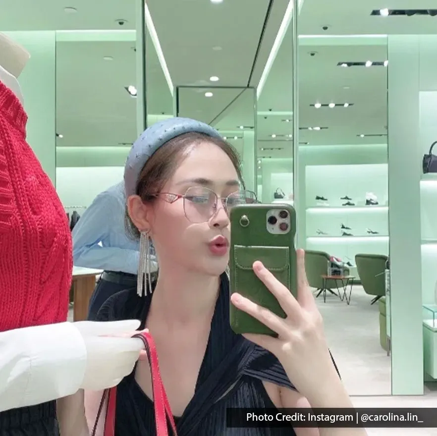 Shopper posing for a mirror selfie inside a designer store at Suria KLCC shopping mall